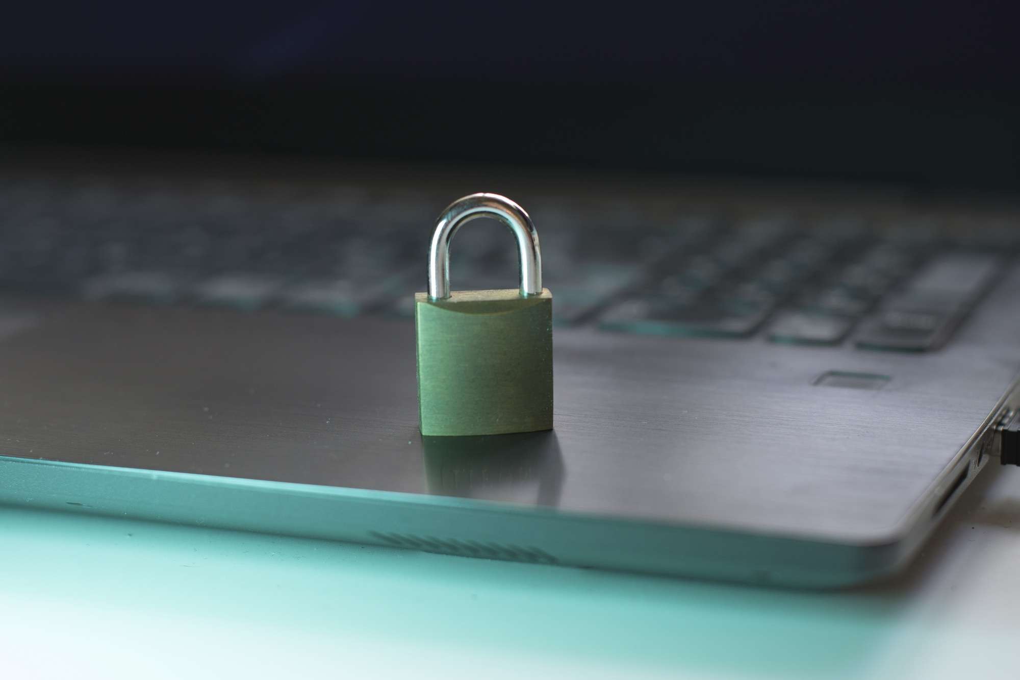 Closeup of closed metal padlock on modern laptop personal data protection Security concept